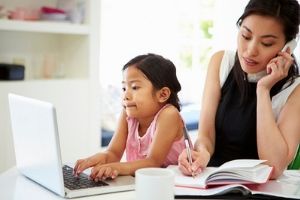 Mom on the phone, daughter on the computer